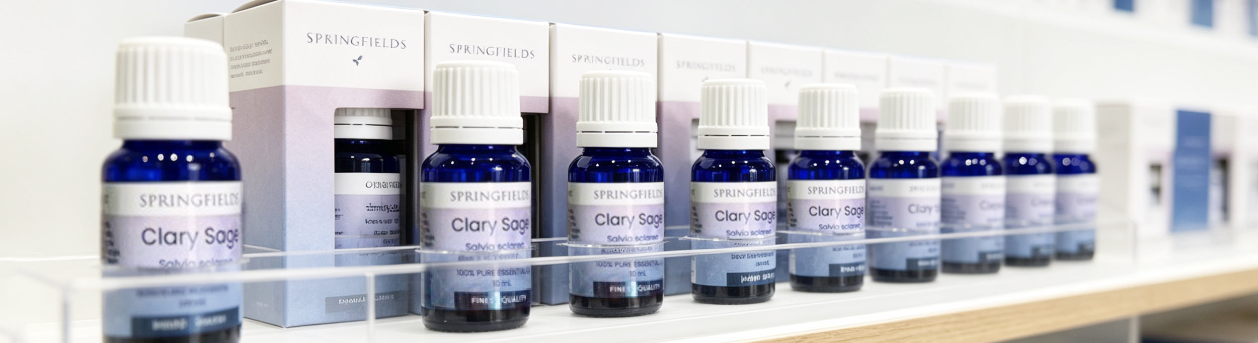 Springfields Clary Sage essential oil bottles and boxes on a shelf
